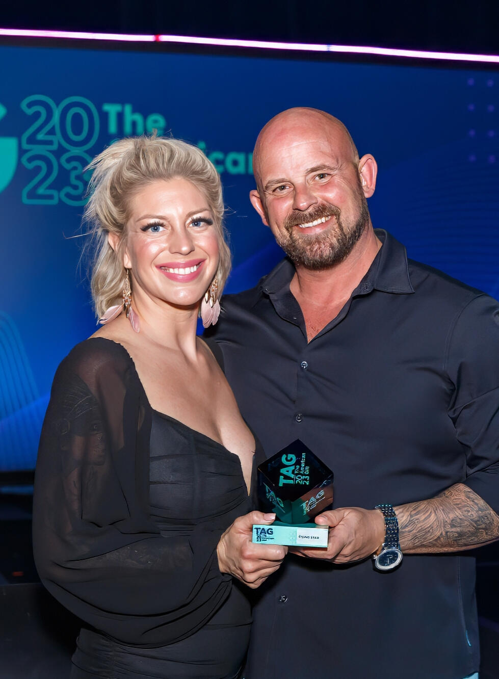 Award recipients posing proudly with their trophy at ceremony in New York City