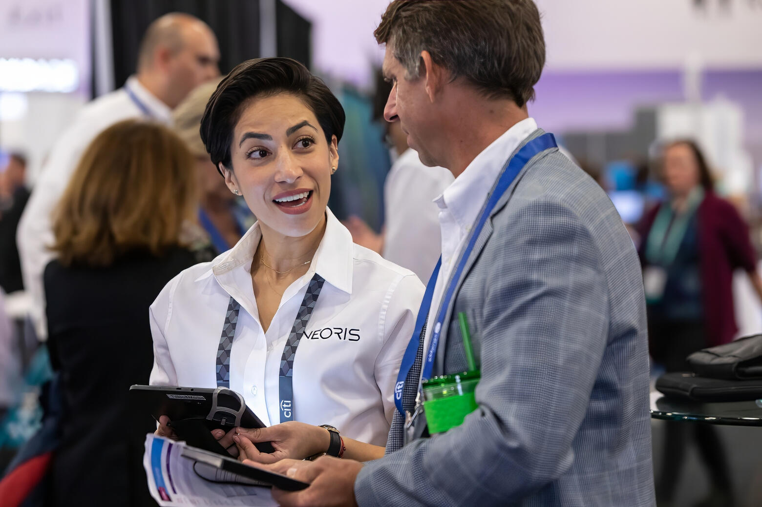Engaged conversation between professionals at a trade show booth during a corporate expo in NYC.