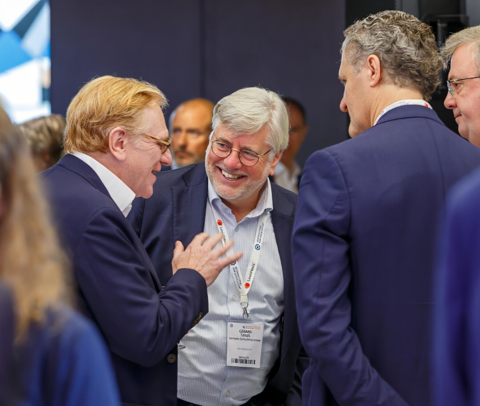 Business professionals engaging in a lively networking conversation during a corporate event in NYC