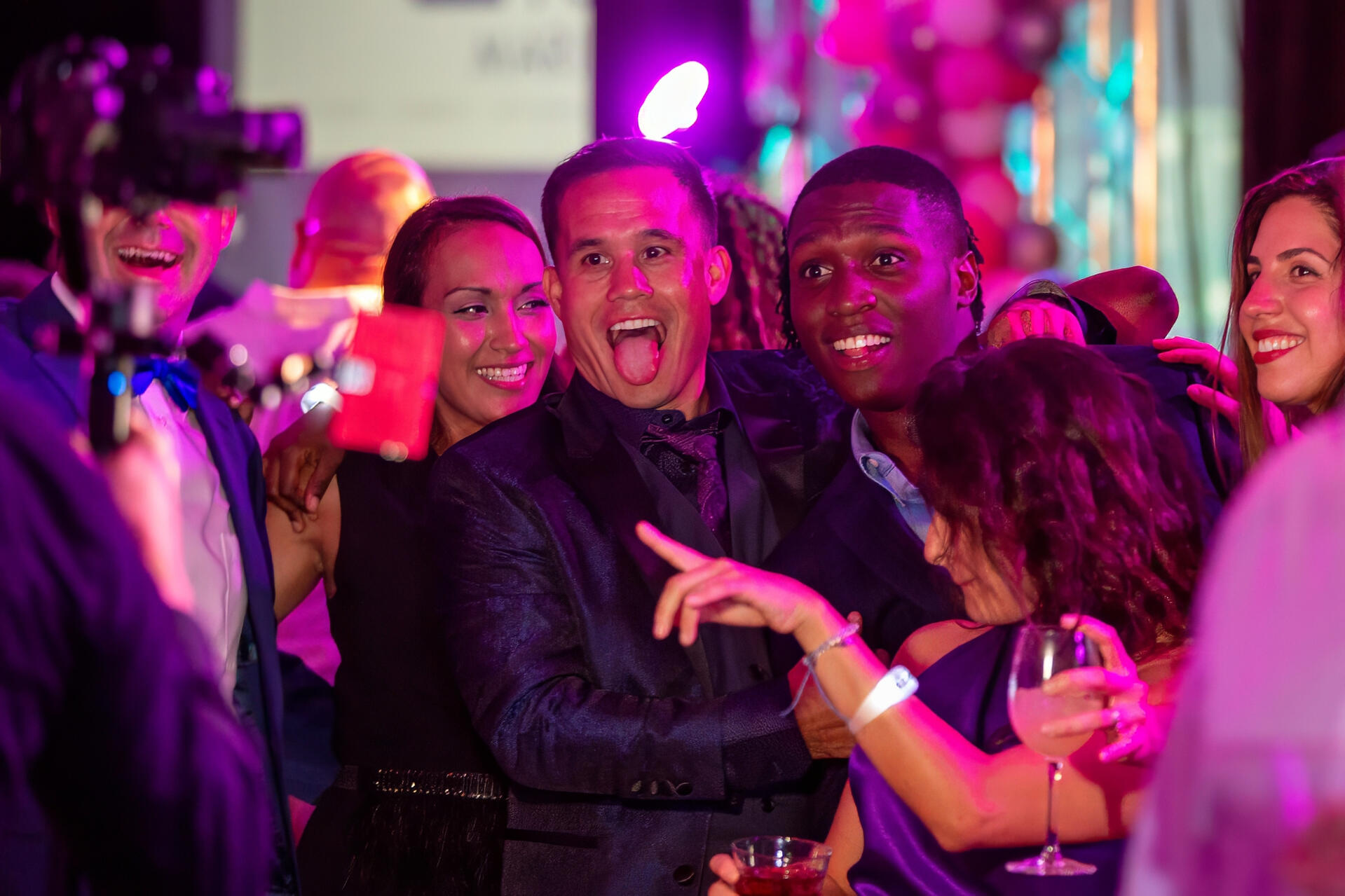 Excited group of colleagues celebrating and posing together at a lively corporate party in New York City